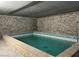 Large indoor pool featuring stonework walls and tile pool at 311 Crestview Dr, Las Vegas, NV 89124