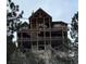 Multi-story log home with multiple decks and stunning views of the surrounding landscape at 311 Crestview Dr, Las Vegas, NV 89124
