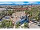 Aerial view of a desert home with a tile roof and lush landscaping at 3235 S Tioga Way, Las Vegas, NV 89117