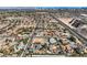 Extensive aerial view of homes with pools, landscaping, and proximity to transportation and desert areas at 3235 S Tioga Way, Las Vegas, NV 89117