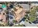 Beautiful property featuring a custom pool with rock features and lush landscaping with palm trees at 3235 S Tioga Way, Las Vegas, NV 89117