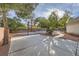 Spacious backyard patio area with basketball hoop and lush landscaping, perfect for outdoor activities at 3235 S Tioga Way, Las Vegas, NV 89117