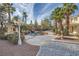 Beautiful backyard with a luxurious pool with a rock waterfall feature, surrounding garden, and gazebo at 3235 S Tioga Way, Las Vegas, NV 89117
