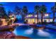 Backyard oasis featuring a pool, rock waterfall, and lush landscaping at 3235 S Tioga Way, Las Vegas, NV 89117