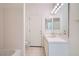 Bright bathroom featuring tiled walls, flooring, a tub/shower combo, and a single sink vanity at 3235 S Tioga Way, Las Vegas, NV 89117