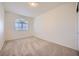 Neutral bedroom with carpet flooring and a window, offering a blank canvas for personalization at 3235 S Tioga Way, Las Vegas, NV 89117
