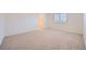 Bright primary bedroom with neutral carpet and baseboards and a window that looks out to the beautiful outdoors at 3235 S Tioga Way, Las Vegas, NV 89117