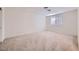 Spacious bedroom featuring plush carpet, window with shutter style blinds, baseboards, and a ceiling fan at 3235 S Tioga Way, Las Vegas, NV 89117