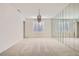 Bright dining room featuring neutral carpet and mirrored wall at 3235 S Tioga Way, Las Vegas, NV 89117