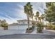Elegant two-story home features a three-car garage, arched windows, and meticulously landscaped front yard at 3235 S Tioga Way, Las Vegas, NV 89117
