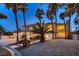 Elegant two-story home with palm trees and manicured landscaping at 3235 S Tioga Way, Las Vegas, NV 89117