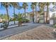 Inviting two-story home with manicured gravel landscaping, mature palm trees, and a grand entrance at 3235 S Tioga Way, Las Vegas, NV 89117