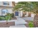 Charming home entrance featuring a walkway, manicured landscaping, mature palm trees, and a stately entrance at 3235 S Tioga Way, Las Vegas, NV 89117