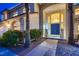 Grand entrance with double doors, lion statues, and lush greenery at 3235 S Tioga Way, Las Vegas, NV 89117
