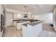 Open kitchen featuring granite counters, white cabinetry, and modern appliances at 3235 S Tioga Way, Las Vegas, NV 89117