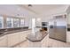 Bright kitchen featuring stainless steel appliances, granite counters, and white cabinetry at 3235 S Tioga Way, Las Vegas, NV 89117