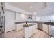 Open kitchen featuring white cabinetry, granite counters, island, and stainless appliances at 3235 S Tioga Way, Las Vegas, NV 89117