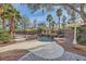 Backyard swimming pool with rock waterfall feature, surrounding garden, and gazebo create a relaxing oasis at 3235 S Tioga Way, Las Vegas, NV 89117