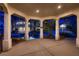 Covered patio view of the custom pool with rock features and palm trees at 3235 S Tioga Way, Las Vegas, NV 89117