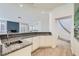 Granite countertop with a wet bar including a sink, cabinetry, and access to the stairs at 3235 S Tioga Way, Las Vegas, NV 89117