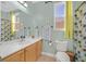 Bright bathroom with shower-tub combo, large mirror, and vanity lighting at 337 Mattie Brook Ave, Henderson, NV 89015