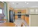 Well-lit kitchen with stainless steel appliances, granite countertops, and seamless flow to the dining area and backyard at 337 Mattie Brook Ave, Henderson, NV 89015