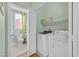 Updated laundry room with washer, dryer, and half bath with shower-tub combo at 337 Mattie Brook Ave, Henderson, NV 89015
