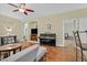 Open living room features hardwood floors, a ceiling fan, and a black piano at 337 Mattie Brook Ave, Henderson, NV 89015