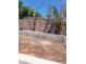 View of the backyard with dirt and brick wall at 3480 E Hacienda Ave, Las Vegas, NV 89120