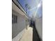 Exterior of a white stucco home with a side entrance and white brick wall for privacy at 3480 E Hacienda Ave, Las Vegas, NV 89120