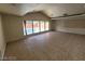 Living room with a vaulted ceiling and a large window overlooking the pool at 3480 E Hacienda Ave, Las Vegas, NV 89120