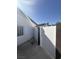 Exterior view of a side yard featuring a stucco wall, a gate, and concrete pavement at 3480 E Hacienda Ave, Las Vegas, NV 89120