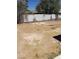 An exterior shot of a desolate backyard featuring a partial view of a wooden fence at 3601 Valley Forge Ave, Las Vegas, NV 89110