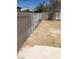 An empty backyard features a cement fence line with a dirt ground at 3601 Valley Forge Ave, Las Vegas, NV 89110