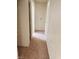 A view of a hallway featuring empty walls, carpeted floors and multiple doorways at 3601 Valley Forge Ave, Las Vegas, NV 89110
