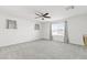 Bright bedroom with ceiling fan, carpet and well-lit by a large window at 371 Triple Falls St, Indian Springs, NV 89018