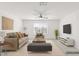 Living room features modern furnishings, neutral walls, carpet flooring, and a large window at 371 Triple Falls St, Indian Springs, NV 89018