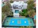 An aerial view of a home with a basketball court, pool, and modern exterior design at 3860 Hildebrand Ln, Las Vegas, NV 89121