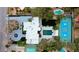 Aerial view showcases the home's expansive lot, pool, tennis court, and pristine landscaping at 3860 Hildebrand Ln, Las Vegas, NV 89121