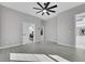 Spacious bedroom with ceiling fan, modern flooring, and an attached bathroom at 3860 Hildebrand Ln, Las Vegas, NV 89121