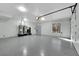 A large garage features epoxy flooring, natural lighting, and multiple water heaters at 3860 Hildebrand Ln, Las Vegas, NV 89121