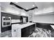 Elegant kitchen with black cabinets, stainless steel appliances, and a center island perfect for meal preparation at 3860 Hildebrand Ln, Las Vegas, NV 89121