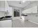 A bright laundry room with a sink, cabinets, and a window providing natural light at 3860 Hildebrand Ln, Las Vegas, NV 89121