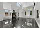 Open-plan living area with fireplace, dual-level floor, and ample natural light at 3860 Hildebrand Ln, Las Vegas, NV 89121
