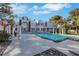 Striking home exterior featuring a pool, pristine concrete, and landscaped surroundings at 3860 Hildebrand Ln, Las Vegas, NV 89121