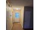 Hallway featuring neutral walls, tile flooring, and a white door with glass panels at 3908 Montebello Ave, Las Vegas, NV 89110