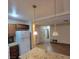 View of kitchen leading to living area, featuring granite countertops and a fridge at 3908 Montebello Ave, Las Vegas, NV 89110