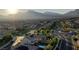 An aerial view of the house with a pool, streets and mountain views provides a landscape perspective at 426 Port Reggio St, Las Vegas, NV 89138