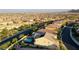 A bird's-eye view of the house and neighboring homes with pool, street and mountain background at 426 Port Reggio St, Las Vegas, NV 89138