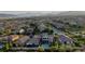 This aerial shot showcases the house with a pool, surrounded by houses, with a scenic mountain view at 426 Port Reggio St, Las Vegas, NV 89138